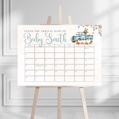 an easel with a baby's birth date card on it in front of a white wall