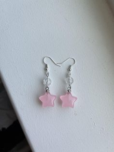 These are cute, handmade pink star earrings. Pink Beads Earrings, Pink Star Outfit, Trendy Pink Jewelry With Star Charm, Star-shaped Crystal Earrings For Gifts, Single Star-shaped Crystal Earring As Gift, Pink Star Charm Dangle Earrings, Pink Dangle Earrings With Star Charm, Trendy Pink Star-shaped Jewelry, Casual Star-shaped Jewelry For Parties