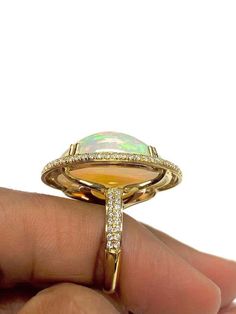 For Sale on 1stDibs - White Opal Cabochon Ring With Diamond in 18K Yellow Gold, from 'G-One' Collection Stone size: 24 X 19 mm Gemstone Weight: 19.20 Carat Diamonds G-H / VS Buying Gold, Ring With Diamond, Cabochon Ring, Good Design, Opal Stone, White Opal, Cocktail Rings, Diamond Ring, Gemstone Rings