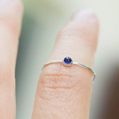 Tiny skinny stackable ring with beautiful deep blue Sapphire stone. It is made with a skinny but sturdy band, which allows you to create mind-blowing stacking sets! The ring is ideal for everyday wear and it will also look amazingly with a festive dress.The ring is 0,8-0,9 mm thick and looks very dainty on the finger. Choose the finish of the stone (smooth cabochon or rose cut) and material for the ring (sterling silver or 9k gold).If you want to change the ring band design or get a custom ring Minimalist Stackable Sapphire Ring, Everyday Stackable Sapphire Ring, Everyday Birthstone Ring With Bezel Setting, Everyday Sapphire Ring With Round Band, Everyday Sapphire Gemstone Ring, Everyday Midi Rings With Birthstone In Round Band, Dainty Sapphire Promise Ring In Sterling Silver, Everyday Gemstone Stackable Rings With Round Band, Dainty Sterling Silver Sapphire Promise Ring