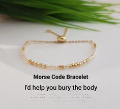 the morse code bracelet is on display next to a plant