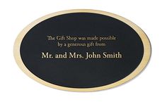 Black oval shaped plaque that recognizes donors. Modern Evening Bag With Gold-tone Logo Plaque, Modern Travel Bag With Silver-tone Logo Plaque, Black Modern Bag With Gold-tone Logo Plaque, Chic Evening Clutch With Gold-tone Logo Plaque, Gold-tone Metal Necklace With Logo Plaque