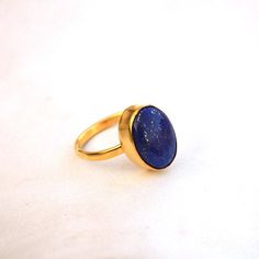 Lapis Lazuli Yellow Gold Ring-9K,14K,18K,22K Solid Gold Rings-January Birthstone Gold Ring -Gold Wedding Ring -Yellow Gold Ring- Lapis Ring Available in 9K,14k,18K,22K yellow solid gold bezel and solid yellow gold ring are both shined to an extremely high polish. But if you prefer it in matte convo me after purchasing. The main stone is natural Lapis Lazuli Gemstone. The pictures have been enlarged to show the details. The band is about 2 mm wide and 1 mm thick. This ring is made to order in you Oval Gemstone Gold Stackable Rings, Classic Gold Stackable Rings With Gemstones, Gold Rings With Gemstone For Fine Jewelry, Gold Opal Ring With Polished Finish As Gift, Gold Crystal Gemstone Ring For Promise, Gold Crystal Gemstone Promise Ring, Gold Signet Ring With Gemstone For Promise, Gold Gemstone Signet Ring For Anniversary, Gold Crystal Promise Ring With Gemstone