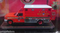 a red fire truck is in a display case with the emblem on it's side