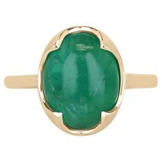 Elevate your style with our mesmerizing emerald cabochon solitaire ring, boasting a stunning 4.29-carat oval cabochon cut emerald sourced from the verdant lands of Zambia, radiating a medium dark green hue with translucent clarity. Embraced by a uniquely crafted four-prong setting in luxurious 14k yellow gold, this ring exudes an irresistible fusion of elegance and eccentricity, making it a standout piece for any occasion. Setting Style: Prong-Solitaire Setting Material: 14K Yellow Gold Setting Weight: 3.0 Grams Main Stone: Emerald Cut: Cabochon Shape: Oval Approx Weight: 4.29-Carats Clarity: Translucent Color: Green Luster: Good Treatments: Natural, Oiling Origin: Zambian Estimated Retail Value: $7,590.00 USD A certificate of appraisal is provided upon purchase. Emerald Cabochon, Emerald Cut Engagement, Solitaire Setting, Modern Engagement Rings, Right Hand Rings, Colombian Emeralds, Yellow Gold Setting, Cabochon Ring, Modern Ring