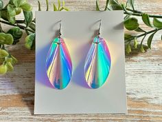 These iridescent teardrop earrings will dazzle you when the light shines through them, while a holographic rainbow will shimmer depending on the background. Holographic earrings are truly unique.  They are super lightweight and are perfect for everyday casual wear. These beauties would also be great for special occasions such as parties, dances, prom, or just a special night out. The holographic nature of these statement earrings make them a fun accessory for both teens and adults.  The nickel f Holographic Earrings, Iridescent Earrings, Earrings Prom, 90s Home, Prom Earrings, Iridescent Crystal, Sensitive Ears, Teardrop Earrings, Handmade Earrings