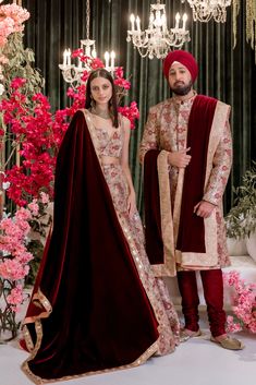 The epitome of opulence in our RAJAN Gold and Red Wedding Sherwani. Adorned with intricate embroidery and dazzling gold sequins, this rosy hued sherwani is a beautiful choice for any Indian groom. With embroidered floral motifs in shades of peach, smoke blue, and mint, this sherwani is the perfect complement to almost any color bridal lehenga. Custom lining color available upon request for a truly personalized touch. Details Thread and Sequin Embroidered Double-layer Tulle Dry Clean Only Item #1 Gold Embroidered Dupatta For Traditional Ceremonies, Red Anarkali Sherwani For Wedding, Floor-length Sherwani With Sheer Dupatta For Reception, Bollywood Style Wedding Sherwani With Sheer Dupatta, Bollywood Style Dupatta With Gold Embroidery For Traditional Ceremonies, Festive Sherwani With Sheer Dupatta For Wedding, Red Anarkali Sherwani With Intricate Embroidery, Festive Wedding Sherwani With Sheer Dupatta, Red Anarkali Style Sherwani For Festive Occasions