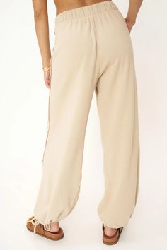 FINAL SALE - NO RETURNS. Feel free to email us at hello@shopmaude.com regarding sizing, fit, or our return policy. We just made the perfect pant. We'll take a bow.The Take A Bow Tie Bottom Parachute Pant is one you'll always find an excuse to wear. This pant features an elasticized high waistband, side pockets, raw edge details throughout, and tie ankle details to create the perfect parachute silhouette. 70% Cotton30% Rayon Care Instructions: Machine wash cold.Wash inside out with similar colors