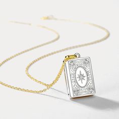 Surprise your loved ones with a treasured keepsake - the Gold and Silver Book Locket Necklace! This exquisite piece features a two-toned gold and silver locket adorned with intricate floral engravings, allowing you to keep cherished memories close. Nestled on radiant 10k gold on brass and accented with shimmering cubic zirconia, it offers a signature finish perfect for best friends, mothers, or partners. A sentimental gift celebrating the bonds you hold dear. 🎁 DETAILS Plating: 10K Gold  Materials: 10K Gold on Silver, Cubic Zirconia Measurements: Length: 15.75 "(40cm)   + Extender: 1.97"(5cm) Pendant Size: 0.47"*0.67"(1.2cm*1.7cm) Weight: 3.8 g Gold Rectangular Pendant Necklace For Keepsake, Vintage Necklace With Engraving Option For Keepsake, Etched Pendant Locket Necklace As A Gift, Keepsake Medallion Locket Necklace With Hallmark, Vintage White Gold Locket Necklace For Gift, Vintage White Gold Locket Necklace Gift, Vintage White Gold Locket Necklace As A Gift, Gold Sterling Silver Locket Necklace, Vintage Charm Rectangular Pendant Jewelry As Gift