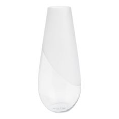 a white vase sitting on top of a table