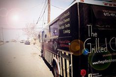 the grilled chef truck is parked on the side of the road in front of an empty street