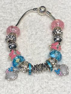 Pandora like charm bracelet MOM or March Birthday, Aquamarine colors. Iridescent pink and blue, cheerful. European fit style. gift for her, includes two dangle hearts with opal like colors and blue and pink butterflies, very sweet Silver plated bracelet.  Barrel snap closure is stamped pandora, faux. Beads are metal alloy, pave rhinestone beads -silver and resin. Very glittery and pretty. lightweight and comfortable. Czech clay rhinestone  and iridescent beads that are very sought after. Romanti European Charm Bracelet, Pink Charm Bracelet For Birthday, Pink Charm Bracelet For Friendship With Lobster Clasp, Trendy Pink Charm Bracelet For Birthday, Cute Blue Charm Bracelet For Friendship, Cute Blue Charm Bracelet For Gift, Blue Friendship Bracelets With Charms, Pink Birthday Charms, Pink Birthday Bracelet With Lobster Clasp