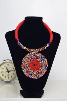 Unique African Maasai Handcrafted Beaded Necklace with an Elegant Look and Brilliant Finish.Color - Red and Mixed Color Beads.Length (Around Neck) - 17 Inches/ 43.2 Centimeters. Length (Downwards)  - 4.5 Inches / 12 Centimeters.**GET FREE SHIPPING FOR ADDITIONAL ITEMS PURCHASED.Yes, Buy Multiple Items and pay shipping for 1 item only- The rest ships Free. (No Limits on the number of Multiple items). With a faster delivery time of 3 days via DHLExpress, Worldwide. Ordinary/Standard Shipping also African Beaded Necklace, Woman Necklace, Multi Coloured Necklaces, African Necklace, Ethnic Necklaces, Handmade Beaded Necklaces, Color Beads, Red Necklace, Maasai