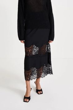 The ankle-length magda skirt is made out of lustrous fabric adorned with two rows of delicate lace trim. meticulously crafted with a commitment to both elegance and an impeccable fit this mid-length skirt discreetly incorporates an elastic waistband seamlessly hidden from the outside.    100% polyester machine wash cold. Black Lace Maxi Skirt Outfit, Black Lace Skirt Outfit, Black Lace Maxi Skirt, Maxi Skirt Winter, Lace Maxi Skirt, Black Lace Skirt, Maxi Lace Skirt, Maxi Skirt Outfits, Swedish Design