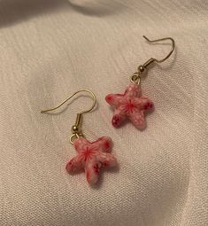 These Dainty, Pink Clay Starfish Drop Earrings are the perfect accessory to complement any outfit. Each pair is handmade and produced in very small quantities, so you're guaranteed to have a unique look.                   ❤ Please note that each earring is not perfeclty identical to its counterpart - our jewelry is made entirely by hand,                        so slight variation does occur.    ------------------------------------------------------------------------------------------------------------------------------------------------------------------------- Caring for your jewelry: ❤ Please handle these earrings with care as they are delicate. Our earrings are made to withstand normal wear, but are vunerable to being damaged if extensive pulling/tugging occurs.  ❤ Avoid getting wet (do Clay Starfish, Starfish Jewelry, Earrings Star, Starfish Earrings, Snowflake Earrings, Star Fish, Pink Clay, Earrings Pink, Silver Shop