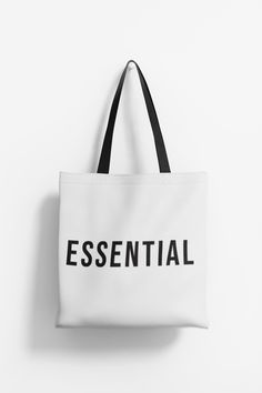 Essential totebag with tasteful text and sleek design. Perfect for everyday use, this tote bag is durable and functional. Its stylish design adds a touch of sophistication to any outfit. Ideal for those who appreciate practicality and style. Product features - 100% Polyester body for strength and durability - Seamless thread color for a polished finish - Reinforced stitching on handles for extra strength - Boxed corners for added room - Available in 5 handle colors and 3 sizes for customization Care instructions - Remove all items from the bag before cleaning. Suggested to pretreat visible stains with stain remover. Mix warm water with laundry detergent and clean the bag with terry washcloth or a soft bristle brush. Let the bag air dry. Modern White Rectangular Canvas Bag, White Rectangular Canvas Bag With Branding, Black And White Rectangular Shopping Bags, White Rectangular Canvas Bag With Eco-friendly Ink, Minimalist Handbag, Eco-friendly Rectangular Canvas Bag With Graphic Print, Card Bag, Market Tote, Essential Bag