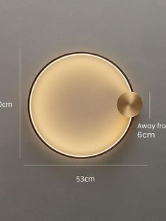 a round light fixture with measurements for the size and width, on a gray wall