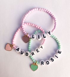 Girls Name Bracelets - Candy Colored The sweetest name bracelet for your little girl. And makes a great gift or baby shower gift ✨ Candy colored 3mm seed beads with personalized name and heart charm Color options available* CARING TIPS FOR YOUR JEWELRY ⭐️Treat and store with care. ⭐️ For longevity, avoid exposing your jewelry to water. ⭐️ Avoid having direct contact with lotions, perfumes, sanitizers as these chemicals may cause discoloration of your jewelry. Trendy Personalized Heart-shaped Friendship Bracelets, Cute Beaded Bracelets For Personalized Gifts, Cute Charm Bracelet With Letter Beads For Birthday, Cute Beaded Name Bracelet Gift, Cute Beaded Name Bracelet As A Gift, Cute Birthday Charm Bracelet With Letter Beads, Cute Beaded Name Bracelet As Gift, Cute Heart Beads Beaded Bracelets For Valentine's Day, Cute Heart Beaded Bracelets For Valentine's Day