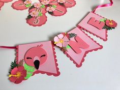 a pink happy birthday banner with flowers on it