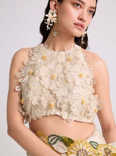 Ivory Daisy Applique Top by Chandrima available on Indiaspopup.com Chic White Organza Tops, Summer Reception Blouse With Floral Embroidery, Sleeveless Blouse With Floral Embroidery For Reception, Sleeveless Organza Tops For Spring, Elegant Sleeveless Embroidered Top For Weddings, Sleeveless Wedding Top With Intricate Embroidery, Silk Top With Floral Embroidery For Reception, Chic Embellished Blouse For Wedding, Festive Floral Embellished Summer Top