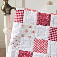 a red and white patchwork quilt on a chair