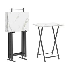 two tables with marble top and black metal legs, one standing on the other side