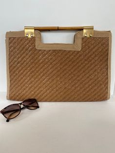 "Gorgeous summer tan clutch bag. Large woven clutch offers lots of room and a small zippered compartment inside with a snap closure. Bamboo handles have gold colored hardware. Label reads- \" made in Italy expressly for fashion imports \"  Dimensions  11 1/2 inches tall and 17 1/4 inches wide  Condition- good vintage  - staining on lining  - some nicks on weave  - light marks on trim - zipper and snap function well  - hardware beautifully intact  Please do not hesitate to ask questions as all sa Leather Backpack Handbag, Tan Clutch, Woven Clutch, Summer Tan, Straw Beach Bag, Bamboo Bag, Summer Tanning, Raffia Bag, Bamboo Handles