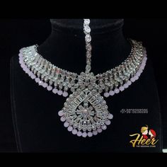 This bridal set is made up with rodium silver polish and gives up an excellent royal look. It comes with Choker, necklace, long haar, earrings, mathapati, Hath Panja, passa. For more designs or any query. Contact us : +91-9079290206 Elegant Hand Set Tikka For Ceremonial Occasion, Elegant Hand Set Ceremonial Tikka, Elegant Ceremonial Hand Set Tikka, Silver Chandbali Jewelry With Elegant Design, Elegant Silver Kundan Necklace With Stone Work, Silver American Diamond Jewelry Sets With Stone Setting, Elegant Silver Jewelry With Stone Work, Festive Silver American Diamond Jewelry Sets, Silver Kundan Necklace For Wedding With Elegant Design