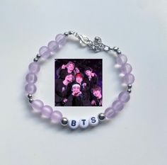 -A cute bts bracelet that not only stretches but it's also adjustable. It comes in multiple colors but mainly in purple. -You can choose the member and color for the bracelet, it does not necessarily has to be the same one from the pics. You can get Yoongi in yellow, or Namjoon in black. -In some of the pics, you can see different size of beads; round and circle. This ones will be random unless you want a specific bead for your bracelet. -Try NOT to expose the bracelet to water, like wearing it to the beach or showering with it. -If you have any suggestions or questions, feel free to message me. I would be more than happy to help! Personalized Kpop Style Jewelry For Friendship, Personalized Kpop Beaded Bracelets, Personalized Adjustable Kpop Style Jewelry, Silver Beaded Bracelets Kpop Style For Gift, Silver Beaded Kpop Bracelets As Gift, Kpop Style Silver Beaded Bracelets, Silver Beaded Kpop Style Bracelets, Trendy Customized Silver Beaded Bracelets, Jewelry Kpop