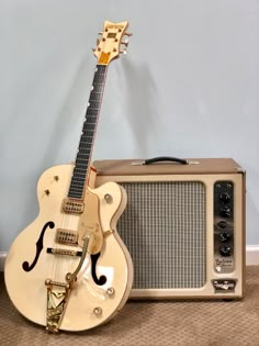 an electric guitar and amp sitting on the floor