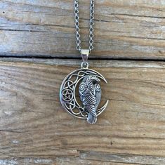 Celtic moon necklace with a Raven......1 1/2" tall with the bail by 1" wide at the widest spot, handmade and antiqued in sterling silver 925...great detail...the chain is 18" long also in sterling silver 925 with a lobster catch Vintage Sterling Silver Moon Phase Necklace, Spiritual Silver Crescent Necklace, Moon Shaped Necklace With Large Pendant, Vintage Silver Necklace With Moon Charm, Symbolic Silver Necklace With Moon Phase, Symbolic Silver Moon Phase Necklace, Handmade Silver Crescent Necklace, Silver Oxidized Moon Shaped Jewelry, Silver Moon Necklace With Engraving