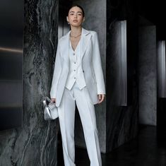 Elevate your bridal style with our exquisite women's 3-piece suit, a blend of elegance, sophistication, and modern flair. Tailored to perfection, this ensemble is designed to make you feel confident and radiant on your special day. Crafted with meticulous attention to detail, our white pantsuit exudes timeless charm and grace. Whether you're walking down the aisle or celebrating at your reception, this suit is a symbol of your unique style and individuality. Each piece of this ensemble, from the White Tailored Pants For Semi-formal Occasions, Luxury White Blazer For Wedding, Luxury White Wedding Blazer, Luxury White Pants For Wedding, White Three-piece Suit For Semi-formal Events, White Three-piece Suit For Semi-formal Occasions, White Tailored Three-piece Suit For Semi-formal Events, White Three-piece Suit With Suit Collar For Semi-formal Occasions, White Tailored Three-piece Suit For Semi-formal Occasions