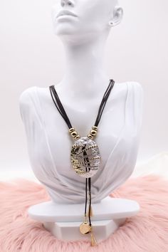 The "Metallic Gold and Silver Pendant with Dangling Stones and Multi Black Rope Necklace" combines a striking pendant crafted from both gold and silver metals, adorned with multiple dangling stones that catch the light with every movement. This intricate pendant is complemented by a necklace made of several strands of sleek black rope, adding a contemporary and bold contrast to the luxurious design. Length: 18” (18 extensions) Pendant: 2.26” (Length) 1.64” (Width) Closure: Lobster Claw Clasp Mat Adjustable Metal Drop Necklace For Party, Party Jewelry With Metal Decoration, Adjustable Metal Long Necklace As Gift, Gold Metal Lariat Necklace For Party, Gold Jewelry With Metal Decoration, Metal Long Dangle Necklace As A Gift, Metal Dangle Long Necklace For Gift, Dangle Long Metal Necklace As Gift, Dangle Long Necklace As Gift