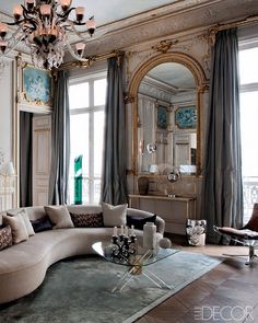 a living room filled with furniture and a chandelier