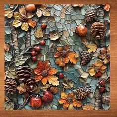 a mosaic with pine cones, acorns and other things on top of it