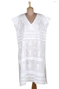 Whether you are relaxing at home strolling a beach boardwalk or sipping a spritz in an Italian cafe this cool and comfortable shift dress is just the ticket. Designed by India's Shalabh the deep v-neck dress features cap sleeves covered buttons on the bodice and traditional chikankari hand embroidery. Summer V-neck Tunic With Chikankari Embroidery, Casual White Tunic Cover-up, White Casual Dress For Resort Season, Casual White Dresses For Resort Season, Casual White Resort Dress, Casual Tunic Cover-up For Resort Season, Casual Short Sleeve Resort Cover-up, Casual Sleeveless Cotton Cover-up, Casual Embroidered Summer Tunic