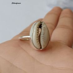 Natural Money Cowrie Sea shell ring, handmade ring, gift ring, Natural Sea shell ring, boho ring, women's ring, statement ring, Gift For Her Benefits Of Gemstone : It brings good luck, wealth, prosperity, fame and the power of destiny. Cowry shells are used in some religious or auspicious ceremonies too, like in Laxmi puja Kaudi shells are kept to please Goddess Laxmi and be blessed by Her and Lord Vishnu Those who have these cowries with them during prayer gets the blessing for both Lord Shiva Handmade Summer Toe Ring Jewelry, Handmade Toe Ring For Summer, Summer Gift Jewelry Open Ring, Silver Shell-shaped Rings For Beach, Summer Shell Jewelry Gift, Silver Shell-shaped Ring For Gift, Silver Shell Rings For Gift, Unique Silver Shell Rings, Shell-shaped Jewelry For Summer Gifts