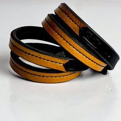 The Leather Wrap bracelets have been a top seller from the beginning. Choose from our everyday leather handbag leathers stitched to the top of our latigo wrap bracelets. Wear alone or layer them for the perfect arm party---these pieces are sure to be a favorite! Layer them all! -Bracelet wraps twice around wrist -3 adjustable sizes Gold Leather Bracelets For Everyday Use, Everyday Gold Leather Bracelets, Leather Bracelet With Black Band For Everyday, Leather Bracelets With Wrist Strap As Fashion Accessory, Everyday Leather Bracelets With Black Band, Handmade Leather Bracelets For Everyday, Handmade Leather Bracelet For Everyday, Everyday Leather Jewelry With Black Band, Brown Leather Wrap Bracelet As Gift