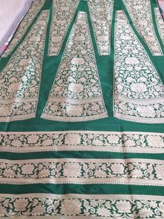 This Banarasi handloom pure silk lehenga is a perfect festive/wedding/occasional wear it enhanced with green color motifs.  Occasion: party wear/wedding  Materials. Pure silk. Unstich  Fabric design - Banarasi  lehenga  Pattern: paisley/buti motifs.  Borders: yes  Border type: Zari  Zari type: golden zari  Fabric length with blouse and with dupatta.  Borders is 6.5 meters  Blouse: 0.85 Meters  No of kali: 18 Size of kali 42 inch  No of border in dupatta 9 Green Tussar Silk Anarkali Set With Resham Embroidery, Green Floor-length Traditional Wear With Cutdana, Green Tussar Silk Set With Resham Embroidery, Green Lehenga With Cutdana In Traditional Drape, Floor-length Green Silk Choli, Raw Silk Floor-length Lehenga With Cutdana, Traditional Green Raw Silk Sharara, Floor-length Raw Silk Lehenga With Cutdana, Green Tussar Silk Set With Dupatta