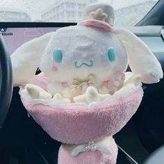 a stuffed animal sitting in the middle of a car