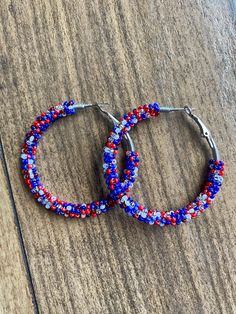 A pair of hoop earrings made with limited edition seed beads in unique matte, opaque and metallic red, white and blue! Comes in 3 sizes! 30mm (1 inch) 40mm (1.5 inch) 50mm (2 inch) These are made from a VERY limited mix so get them while you can! These one of a kind earrings are fantastic for raves, night clubs, parties, summer vacations, festivals or just for a pop of color in your wardrobe.  Made with a spring clasp for ease. Hypoallergenic professional grade metals, none of the cheap stuff us Festive Multicolor Hoop Earrings, Bohemian Blue Hoop Earrings With Colorful Beads, Unique Multicolor Beaded Hoop Earrings, Multicolor Nickel-free Hoop Earrings For Festivals, Cheap Stuff, Orange Nickel-free Bohemian Hoop Earrings, Night Clubs, Boho Hoop Earrings, Summer Vacations