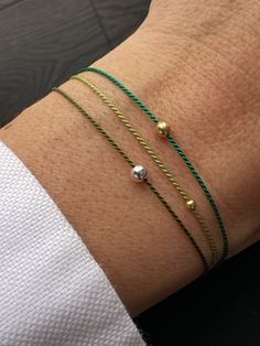 This silk string bracelet is made from silk cord and solid 14K gold, sterling silver, or  24K gold bead. Waterproof silk let you wear bracelet all the time without taking off.  Protection  bracelet is a beautiful way to give someone you care.  It is perfect gift for sister or for couple too. You can choose men size in personalization section.  Details:  * 14K solid gold, sterling silver or 24K gold vermeil bead 2 or 3 mm. Silk String * Adjustable clasp gold vermeil; 🎁 READY AS A GIFT! GIFT MESSAGE AVAILABLE (please write the message in the comments field)  It comes with beautiful packaging box.  Bracelet is adjustable, so it will fit for everyone. If you need man size, leave me a note. Thank you for shopping at Therapy handmade accessories! Single String Bracelet, Good Luck Bracelet, Green Dragon, Jewelry Tattoo, Gold Silk, Protection Bracelet, String Bracelet, Beaded Material, Bead Jewellery