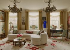 a living room filled with lots of furniture and decor on top of a white rug