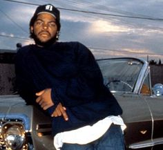 a man leaning on the hood of a car