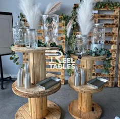 two wooden tables with glass vases on them