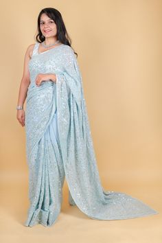 Take elegance to the next level with our stunning Georgette saree in a magnificent shade of blue. Adorned with delicate sequins, this saree exudes sophistication and luxury. Perfect for special occasions or to add a touch of glamour to your everyday look. Elevate your style with this exquisite saree. Georgette saree with sequins - Blue Saree comes with a blouse piece. Fall and pico done. Fully stitched blouse shown in pictures is optional and can be purchased seperately from our blouses and croptops section. For saree video please connect with us on whatsapp @469-937-0606 Ready to be shipped in USA from San Diego, California. All pictures are original pictures. Colors may slightly vary due to pic resolution. Blue Floor-length Pre-draped Saree With Mirror Work, Bollywood Style Pre-draped Saree With Sequins, Georgette Pre-draped Saree With Sequins For Reception, Reception Georgette Pre-draped Saree With Sequins, Designer Wear Pre-draped Georgette Saree With Sequins, Blue Pre-draped Saree With Mirror Work, Festive Sequined Pre-draped Saree, Party Wear Pre-draped Saree With Sequins, Reception Semi-stitched Sequined Pre-draped Saree