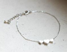 "This is very cute and simple necklace. This cute bracelet made with matt white gold plated hearts and white gold plated chain,clasp. + Three hearts measures is approx. 18 mm wide. + bracelet total length : 8 inches (including 1.5\" extension chain) (you can adjust different length, simply leave a note to me when you order otherwise you'll get 6.5\" plus 1.5\" extension chain) If you want different length, please simply leave a note to me when you order. + white gold plated chain and clasp can b Silver Heart Bracelet As Gift For Mom, Silver Heart Bracelet Gift For Mom, Minimalist Silver Heart Bracelet For Anniversary, Silver Minimalist Heart Bracelet For Valentine's Day, Minimalist Silver Heart Bracelet For Valentine's Day, Minimalist Silver Heart Bracelet In Stainless Steel, Delicate Silver Heart Bracelet Gift, Minimalist Stainless Steel Heart Bracelet, Simple Silver Jewelry For Mother's Day