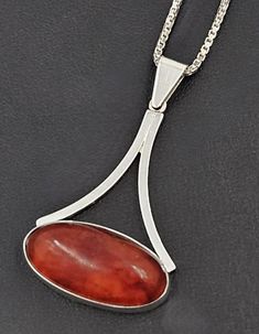 Rare Henning Ulrichsen Sterling & Amber Large Modernist Pendant Necklace 1960s Measurements: Pendant: 1.75"L x 1.05"W x .4"Thick (4.45cm x 2.67cm x 1.02cm) Chain: 30"L (76.2cm) Markings: 925S Maker's Mark Handmade Denmark Weight: 12.1g Beautiful Danish modernist sterling silver and Amber pendant. Pendant is in excellent condition with only minor wear to the back, Amber is fully intact. I have paired it with an extra long sterling silver chain. Stunning and timeless necklace. Mannequin is a life-size torso representation Henning Ulrichsen A/S is 100% a danish family owned jewelry company that was founded in 1951 by the master goldsmith and jeweler Henning Ulrichsen. Their first workshop was placed in Herning and was moved to the current address north of Copenhagen in 1996. Modernist Oval Jewelry For Formal Occasions, Formal Teardrop Cabochon Necklace, Mid-century Handmade Formal Jewelry, Modernist Hallmarked Oval Jewelry, Collectible Modernist Pendant Necklace, Modernist Pendant Jewelry For Formal Occasions, Modernist Formal Pendant Jewelry, Modernist Pendant For Formal Occasions, Vintage Polished Pendant Necklace