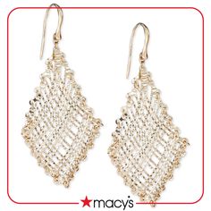 pair of gold tone earrings with white beading on the front and back ends, hanging from