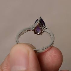 This is a gorgeous handmade creation. Its beauty is its simplicity & Elegance. The 6*9 mm pear shape faceted natural amethyst is crafted in solid sterling silver and with rhodium plated. All item is sent in a beautiful gift box If you have any idea of design your ring,pls contact me directly. You can realize more lovely stuff clicking the link https://www.etsy.com/shop/knightjewelry?refshopsection_shophome_leftnav Please leave the correct address and you phone number for delivering successfu Pear-shaped Purple Amethyst Ring With Prong Setting, Purple Pear-shaped Amethyst Ring With Prong Setting, Purple Teardrop Amethyst Ring For Anniversary, Fine Jewelry Teardrop Purple Ring, Teardrop Amethyst Ring For Formal Occasions, Fine Jewelry Purple Teardrop Ring, Elegant Teardrop Amethyst Ring, Purple Teardrop Fine Jewelry Ring, Formal Teardrop Amethyst Ring